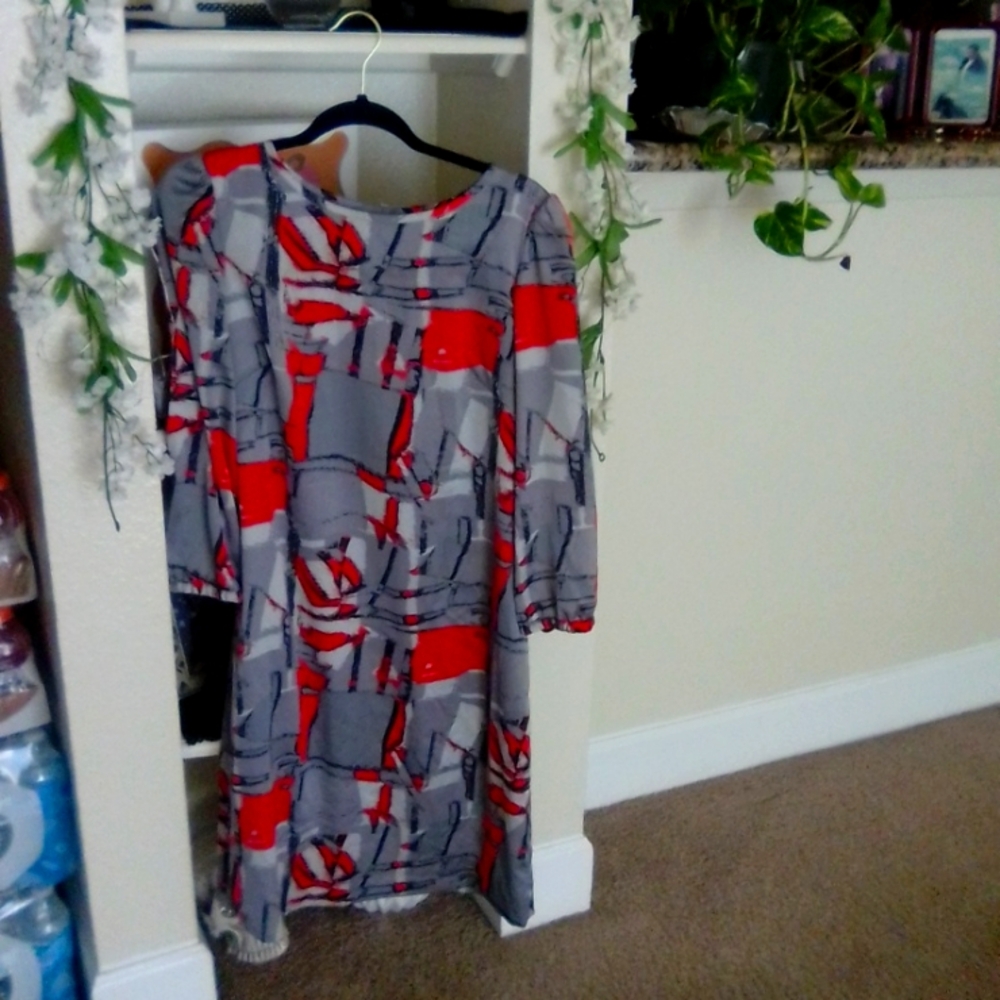 Knee length, long sleeve dress . Four buttons at knock line 1 button on each arm